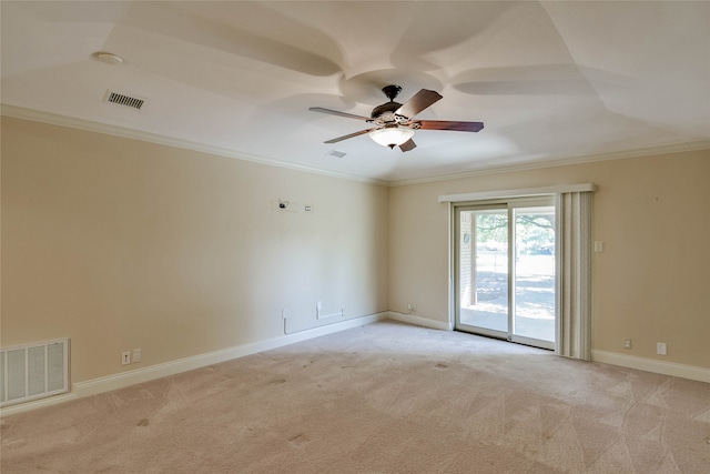 carpeted spare room with ceiling fan and ornamental molding