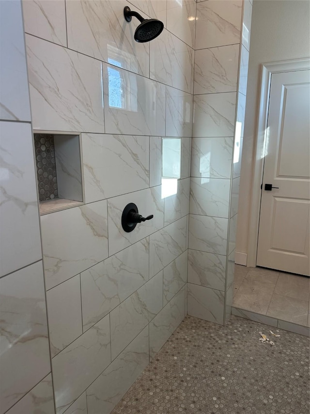 bathroom with tiled shower