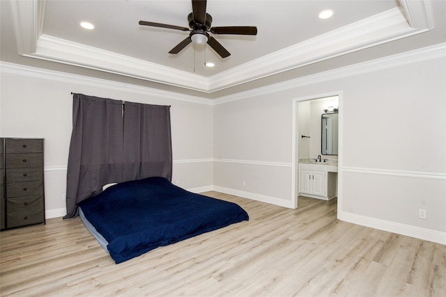 unfurnished bedroom with crown molding, a tray ceiling, ensuite bathroom, and ceiling fan