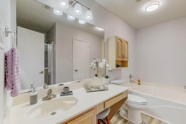 full bathroom featuring vanity, plus walk in shower, wood-type flooring, toilet, and a textured ceiling