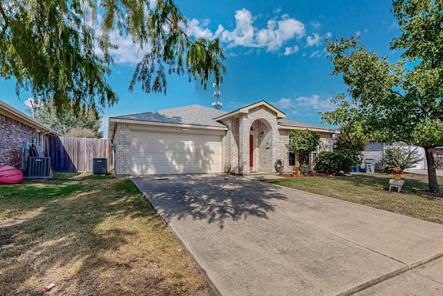 single story home with central AC unit, a front yard, and a garage