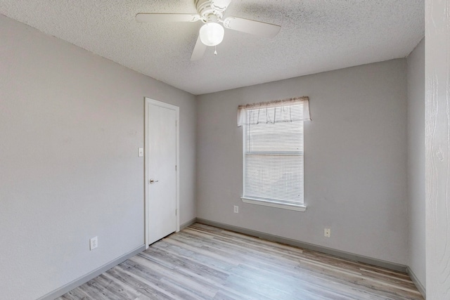 spare room featuring ceiling fan, a textured ceiling, and light hardwood / wood-style floors