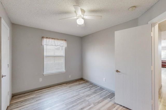 full bathroom featuring vanity, toilet, a textured ceiling, and shower / tub combo with curtain