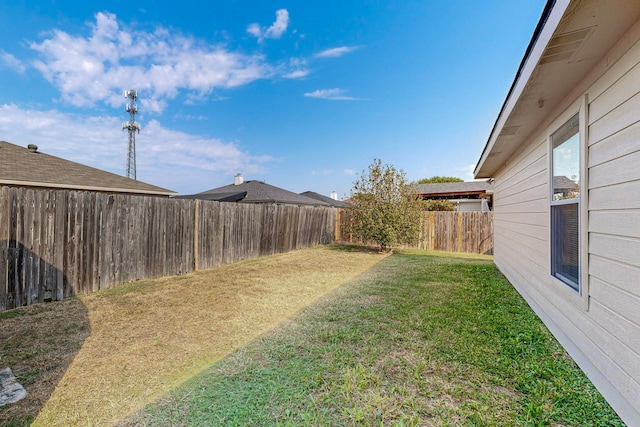 rear view of property featuring a storage unit and a lawn