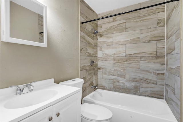 full bathroom with tiled shower / bath combo, vanity, and toilet