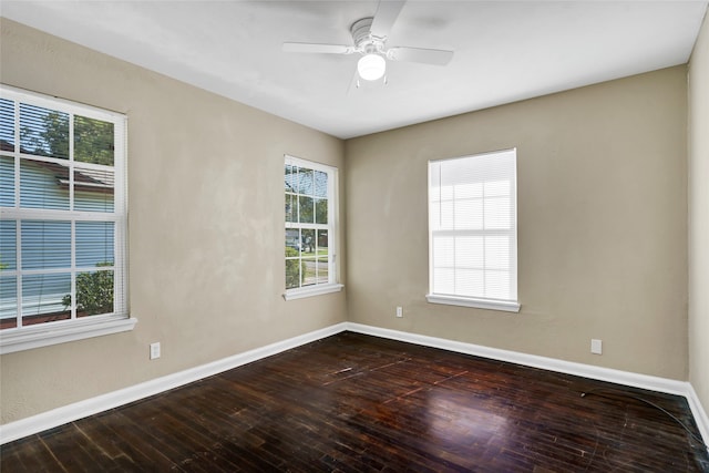 empty room featuring ceiling fan, dark hardwood / wood-style flooring, and a healthy amount of sunlight