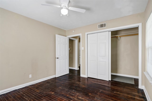 unfurnished bedroom with ceiling fan, a closet, and dark hardwood / wood-style flooring