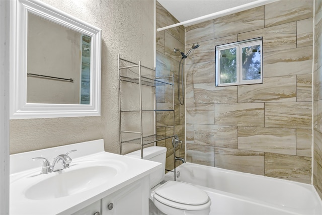 full bathroom with tiled shower / bath, vanity, and toilet