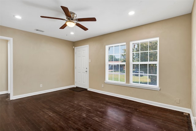 empty room featuring ceiling fan and dark hardwood / wood-style flooring