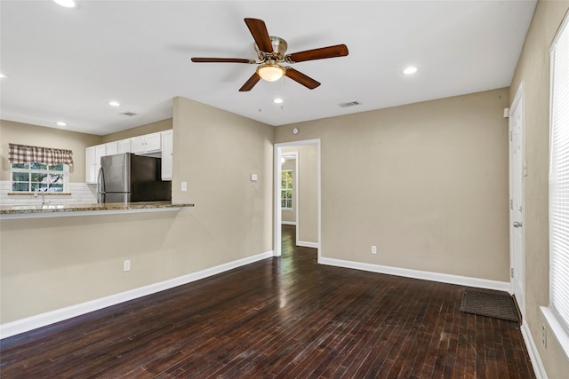 unfurnished living room with ceiling fan, hardwood / wood-style flooring, and sink