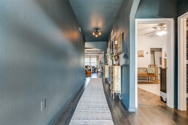 hallway with dark hardwood / wood-style floors