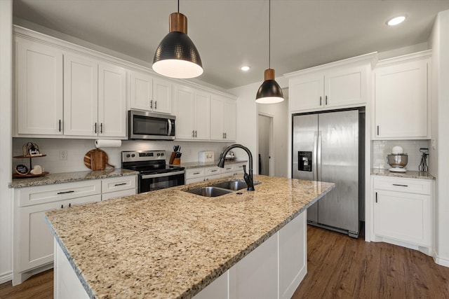 kitchen featuring white cabinetry, sink, hanging light fixtures, and appliances with stainless steel finishes