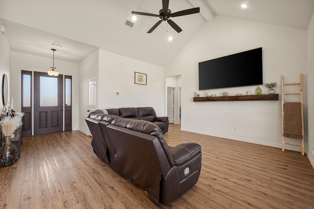 living room with beam ceiling, light wood-type flooring, high vaulted ceiling, and ceiling fan