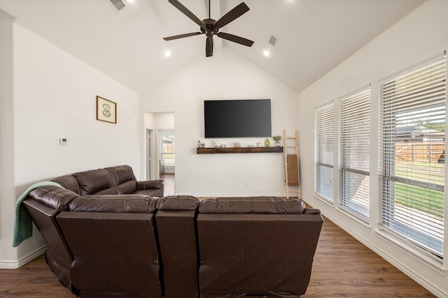 living room featuring hardwood / wood-style flooring, plenty of natural light, ceiling fan, and high vaulted ceiling