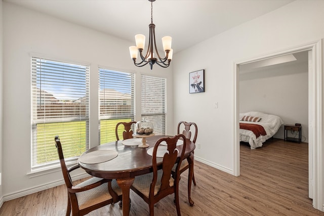 dining room featuring hardwood / wood-style flooring and a notable chandelier