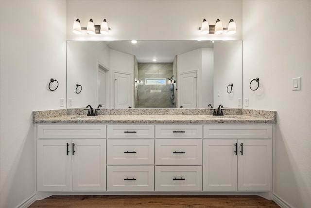 bathroom with vanity, an enclosed shower, and hardwood / wood-style flooring