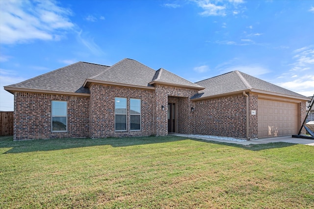 view of front of property featuring a garage and a front lawn