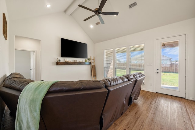 living room with beamed ceiling, light hardwood / wood-style floors, high vaulted ceiling, and ceiling fan