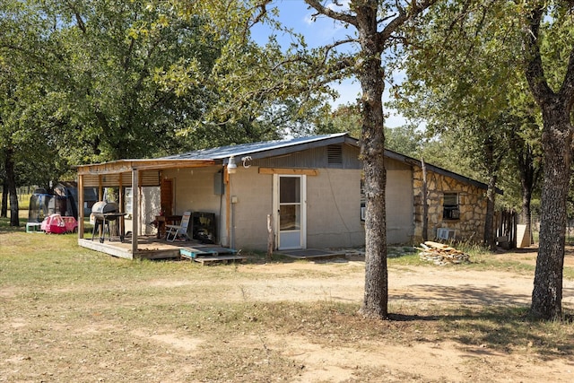 1455 County Road 2008 Unit B, Glen Rose, TX 76043 - back of house with concrete block siding and a lawn