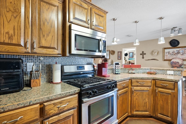 1455 County Road 2008 Unit B, Glen Rose, TX 76043 - kitchen featuring stainless steel appliances, brown cabinets, and decorative backsplash