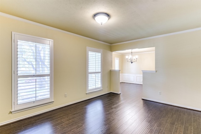 unfurnished room with dark wood-style floors, a textured ceiling, an inviting chandelier, and ornamental molding