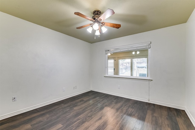 unfurnished room featuring baseboards, a ceiling fan, and dark wood-style flooring