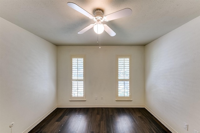 unfurnished room featuring dark hardwood / wood-style floors, a wealth of natural light, and a textured ceiling