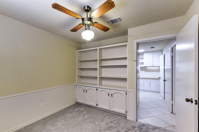 tiled office featuring built in desk and ceiling fan