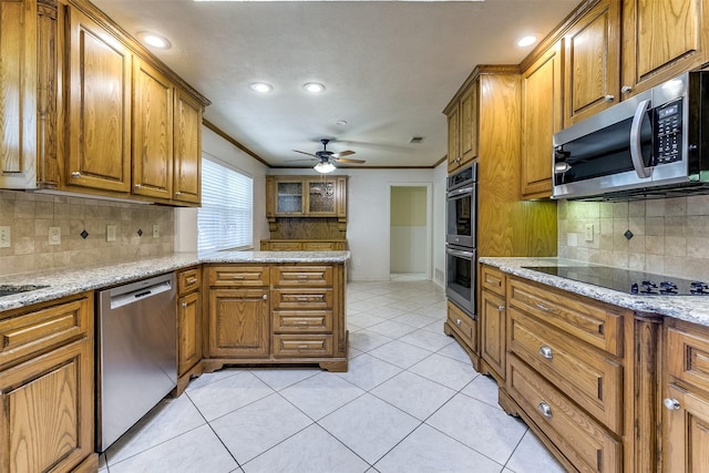 kitchen with brown cabinetry, light tile patterned floors, stainless steel appliances, and crown molding