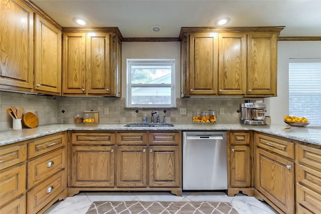 kitchen with brown cabinets, a sink, crown molding, decorative backsplash, and dishwasher