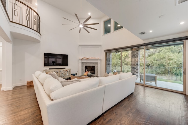 living room featuring dark hardwood / wood-style floors, high vaulted ceiling, and ceiling fan