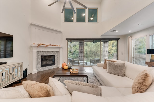 living room featuring dark hardwood / wood-style floors and a high ceiling