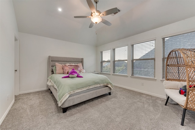 bedroom with ceiling fan, light colored carpet, and vaulted ceiling