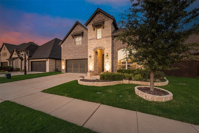 view of front of property with a lawn and a garage