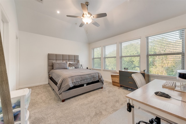 carpeted bedroom with ceiling fan and vaulted ceiling