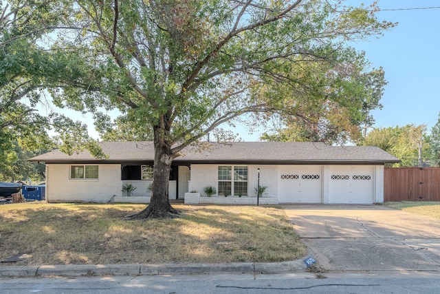 ranch-style home featuring a garage and a front yard