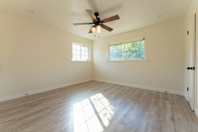 spare room featuring light wood-type flooring and ceiling fan