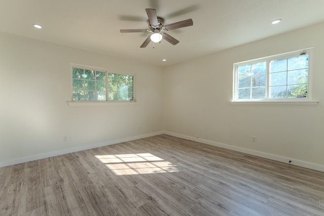 empty room featuring light wood-type flooring and ceiling fan