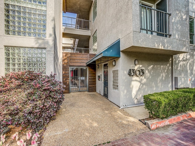 view of exterior entry featuring a balcony