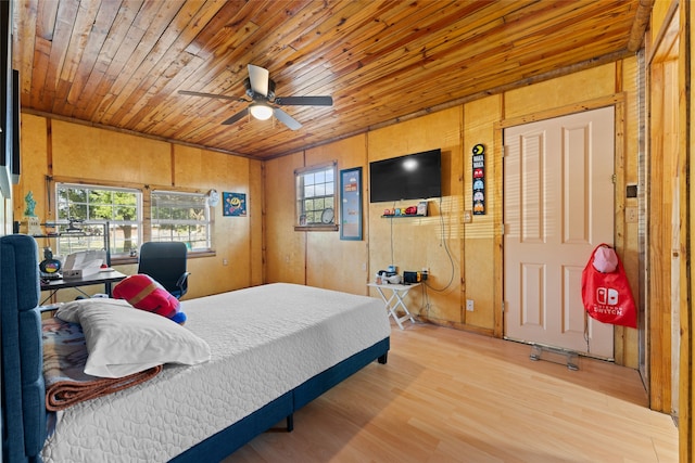 bedroom with wood walls, wood-type flooring, wood ceiling, and ceiling fan