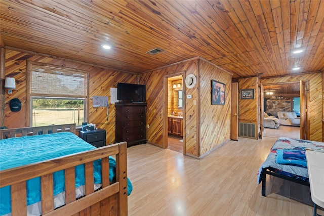 bedroom featuring wooden walls, wooden ceiling, and light hardwood / wood-style floors