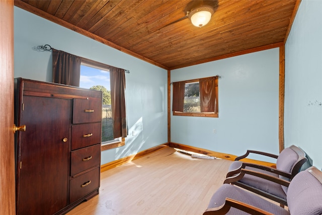 sitting room with light hardwood / wood-style flooring, crown molding, and wooden ceiling