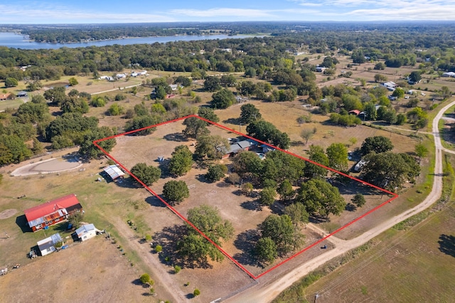 drone / aerial view featuring a water view and a rural view