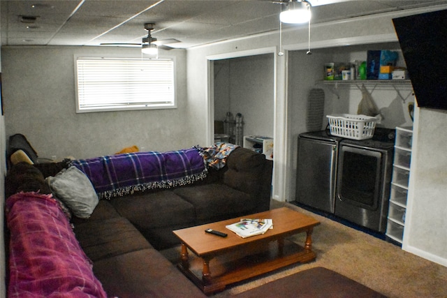 living room featuring carpet flooring, ceiling fan, and washing machine and dryer