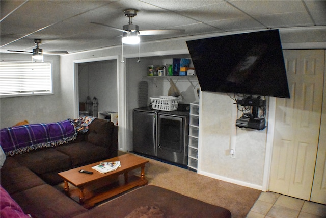 tiled living room featuring washer and dryer, ceiling fan, and a drop ceiling