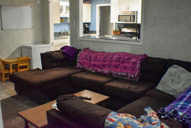 living room featuring light tile patterned floors and sink