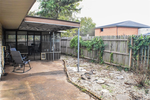 view of patio with a sunroom