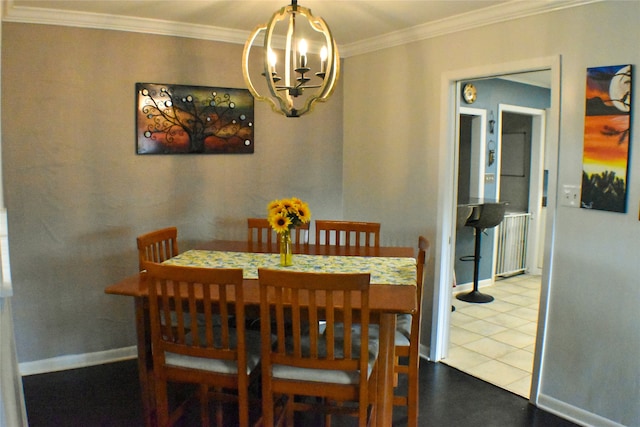 dining area featuring tile patterned floors, a notable chandelier, and ornamental molding