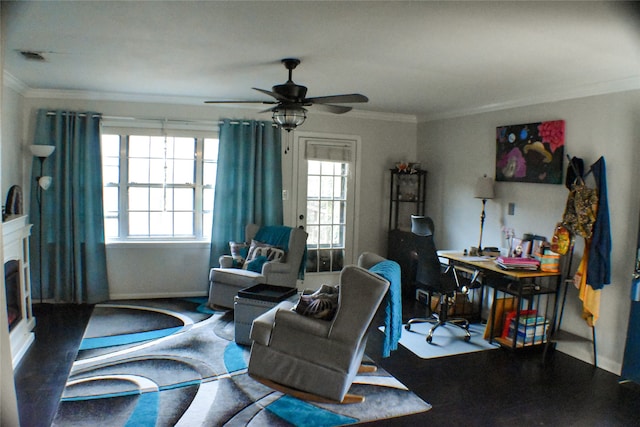 living room featuring ceiling fan, crown molding, and a wealth of natural light