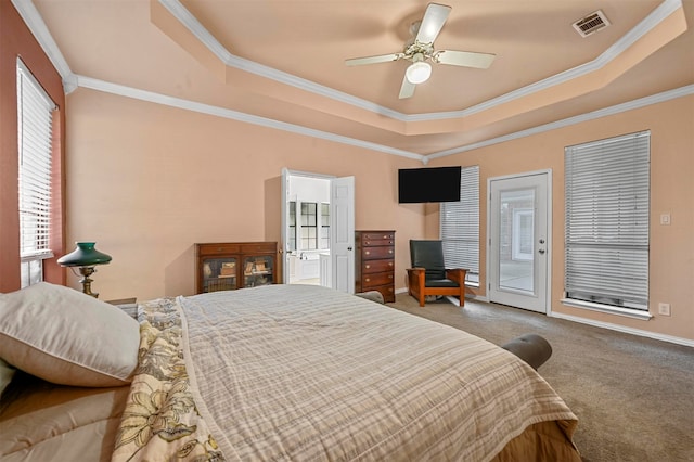 carpeted bedroom with ceiling fan, access to exterior, a tray ceiling, and ornamental molding